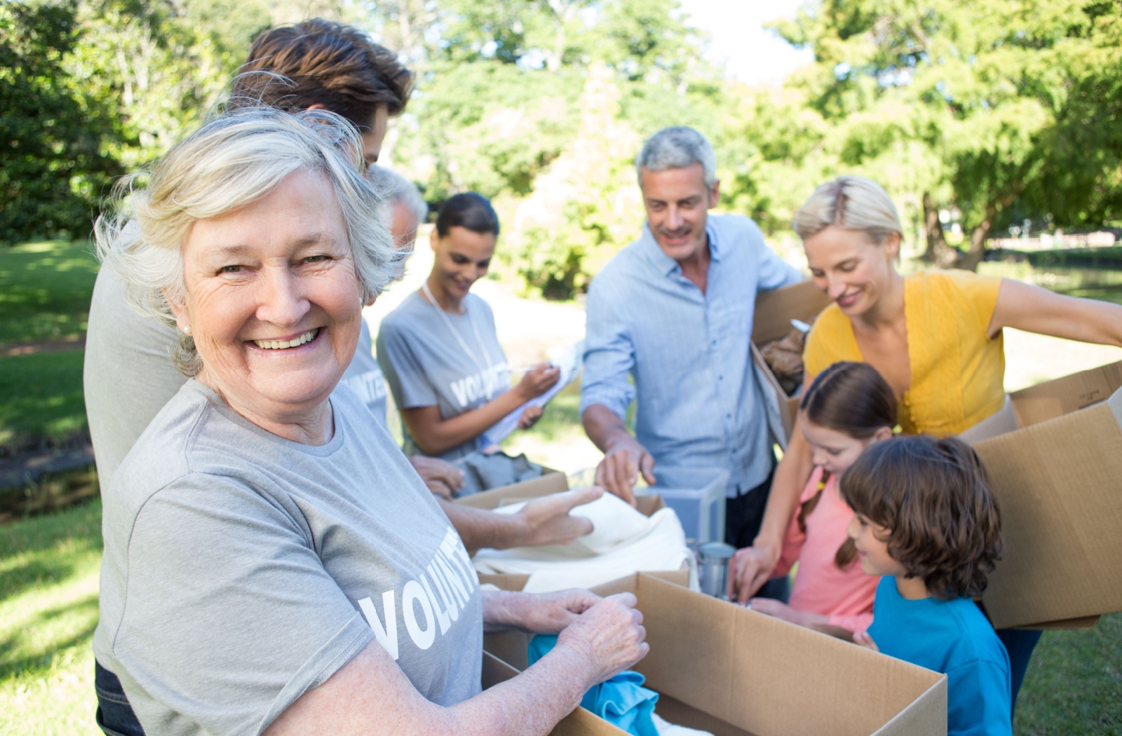 A smiling senior participating as a volunteer with a local oranigaztion.