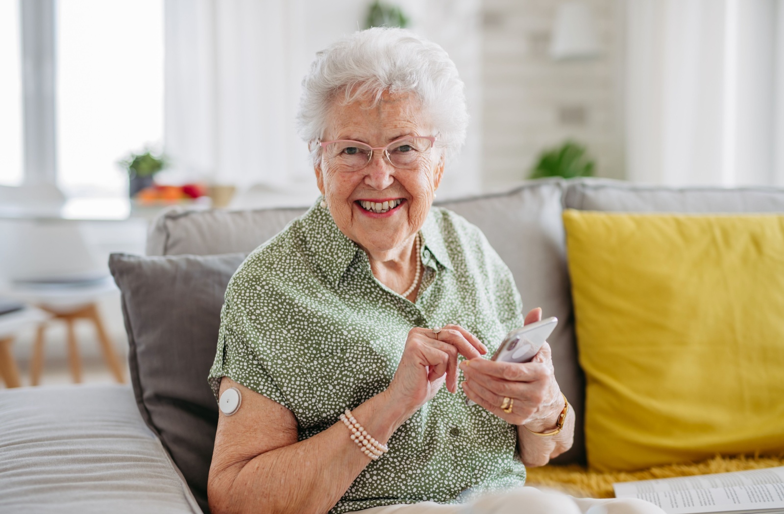 A senior using a cellphone, staying connected with family through calls and messages.