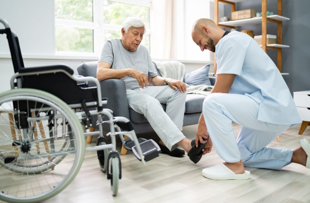 a caregiver helping a senior taking out their shoes